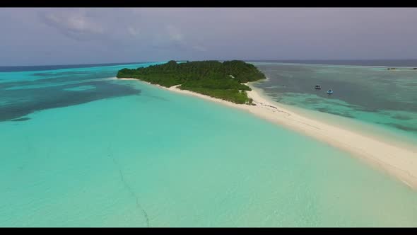 Aerial flying over scenery of relaxing resort beach adventure by blue green ocean with white sand ba