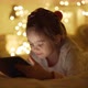 Girl Using Tablet in Illuminated Bedroom - VideoHive Item for Sale