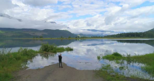 Aerial view of mature woman standing near a lake