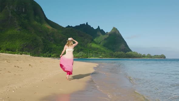 Woman in Dress Running By Beach Mountain Peaks Background Sunrise Slow Motion