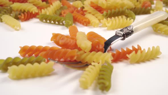 Multicolor vegetable pasta on a beautiful fork 