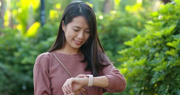 Woman use of smart watch in the park