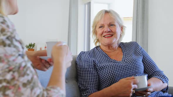 Mother and daughter interacting with each other in living room 4k