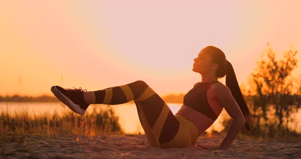 Fitness Woman Doing Crunches at the Beach