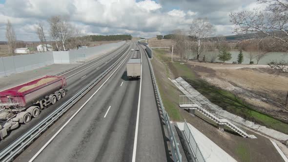 Top view of trucks driving on motorway in spring