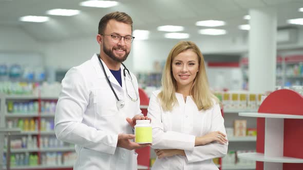 Two Beautiful Pharmacist in Uniform Recommends the Drug for Treatment
