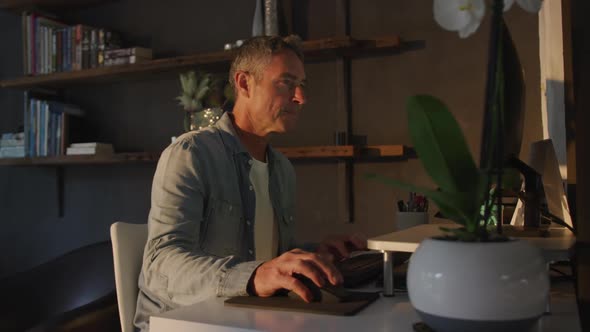 Man using computer at home at night