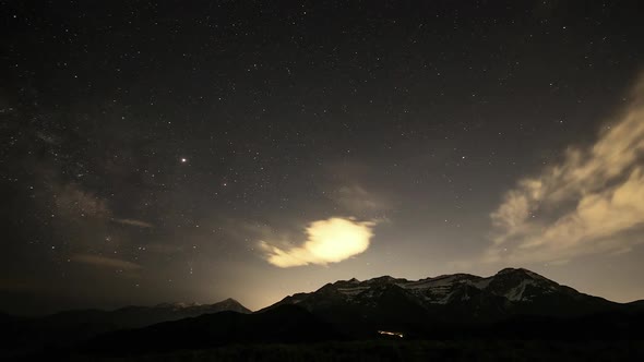 Star time lapse of the Milky Way in the sky over mountain range