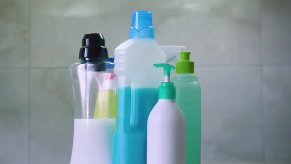 Circular panorama around the bottles and containers with household chemicals