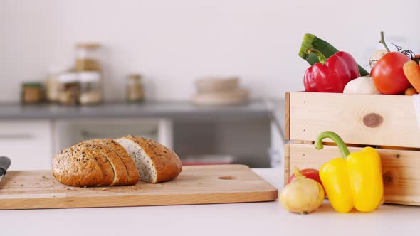 Bread on Cutting Board and Vegetables at Home 4