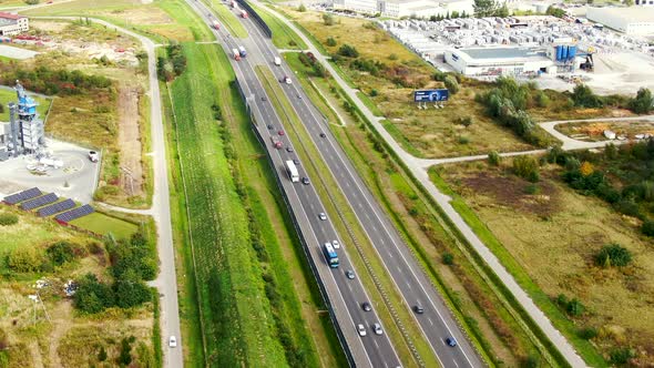 Big logistics terminal in countryside near highway, Delivery center traffic on the highway aerial sh