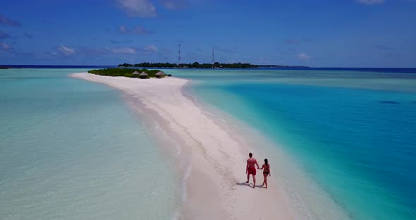 Young people on honeymoon vacation live the dream on beach on white sand 4K background