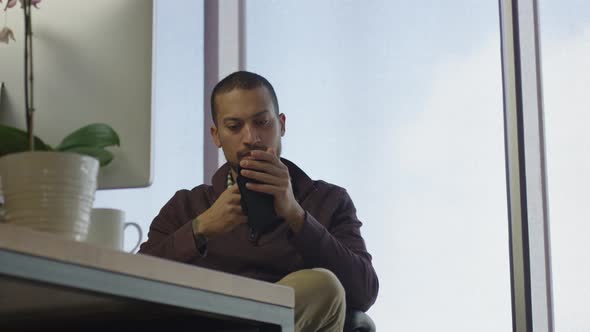 African american man at his desk with his dog at high tech job