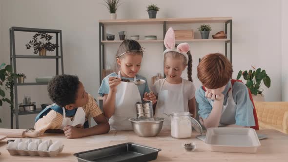 Diverse Kids Sifting Flour in Kitchen