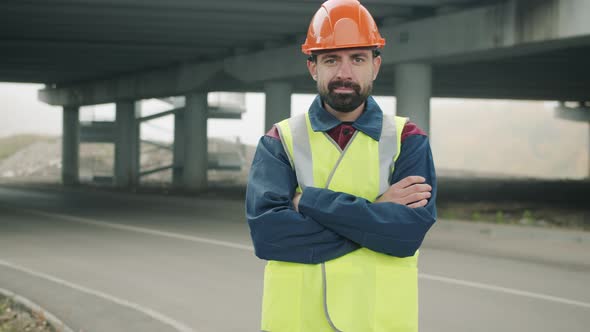 Portrait of Confident Foreman Standing Outdoors with Construction Site in Background