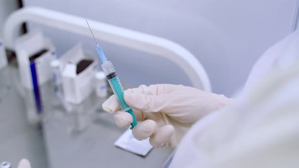 The Nurse Draws the Vaccine Into a Syringe