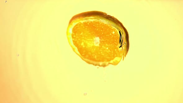 Sliced orange spinning in water, Slow Motion