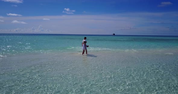 Happy couple married on vacation enjoy life on beach on clean white sand background 4K