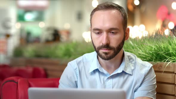 Portrait of Pensive Young Businessman Confident Looking at Screen Using Laptop