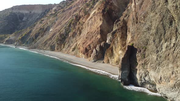 Aerial View From Above on Calm Azure Sea and Volcanic Rocky Shores