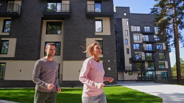 Happy Active Couple Running at Park Near with Home