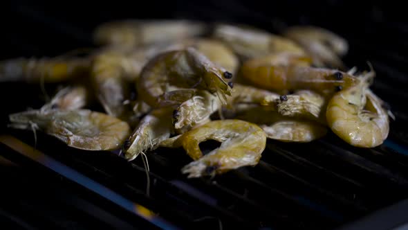 Barbecue Tongs Pile up Grilled Shrimps.