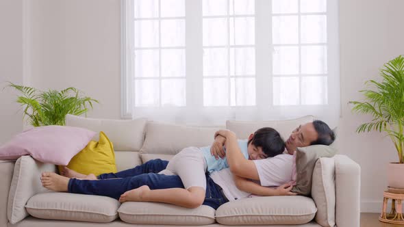 Father and son hugging on the sofa