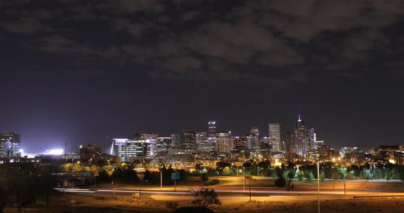 Time lapse of Denver skyline at night with light streaks from cars
