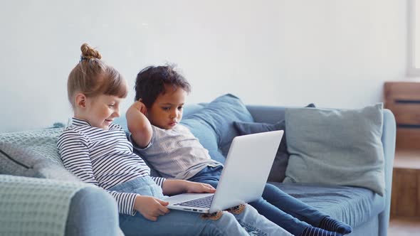 Education, School, Technology and Internet Concept - Little Student Girl and Boy with Laptop Pc