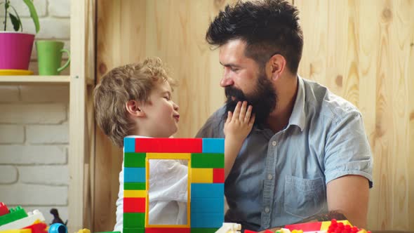 Smiling Father and Preschooler Son Hug Cuddle Together, Happy Dad and Cute Little Boy Child Show