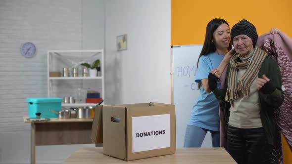 Young Activist Donating Coat Poor Senior Woman, Humanitarian Aid, Social Project