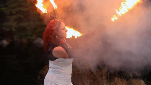 Woman Performing Fire Spinning with Smoke