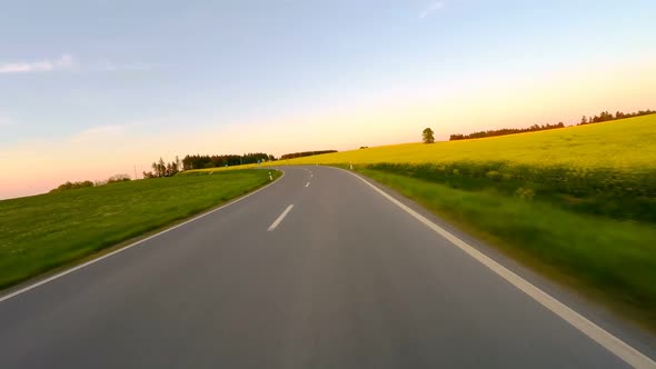 Car driving in spring rural countryside road