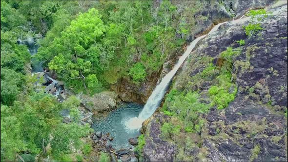 Aerial View of Highland with Waterfall Among Forestry Rocks