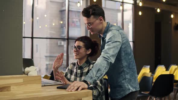 A Young Couple in Love Announcing Their Engagement to Someone Through Video Chat