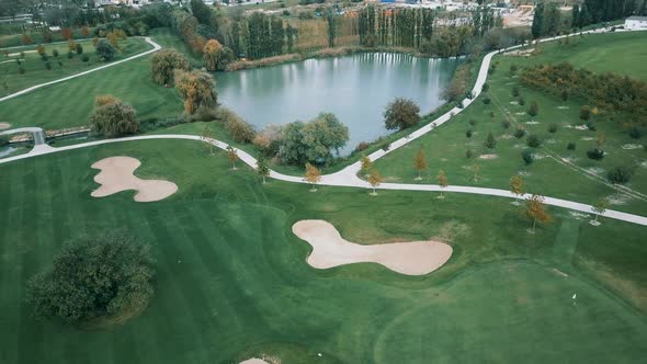 Incredibly beautiful scenery of spacious manicured meadows with garden trees and a picturesque lake