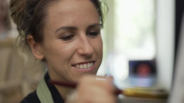 Cheerful Woman Drawing a Picture at Art Studio