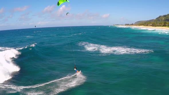 Aerial view of a man kitesurfing in Hawaii.