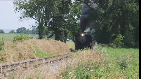 Steam Train Puffing Smoke Along Countryside