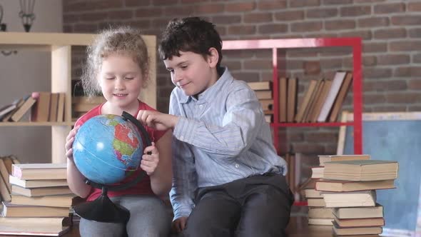 school children laugh and play with globe. Home education.