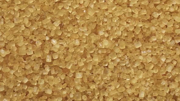 Golden cane sugar crystals full frame close up as a background  