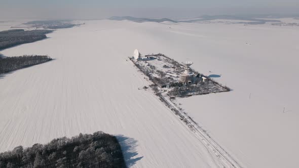 Aerial View of the Space Communication Station in Snow Covered Field at Sunny Winter Day Drone