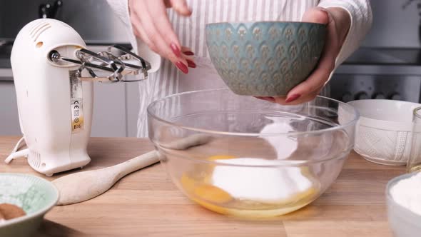 Woman Combine White Sugar In Eggs On A Glass Bowl - Making A Delicious Carrot Cake. - close up, slid