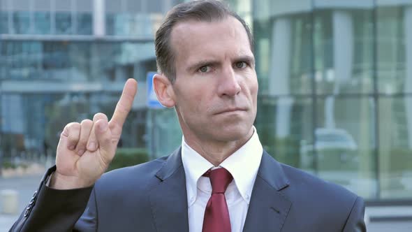 No Middle Aged Businessman Rejecting Offer By Waving Finger