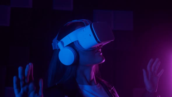 Closeup Creative Woman in Futuristic VR Headset Gesturing with Hand While Interacting with