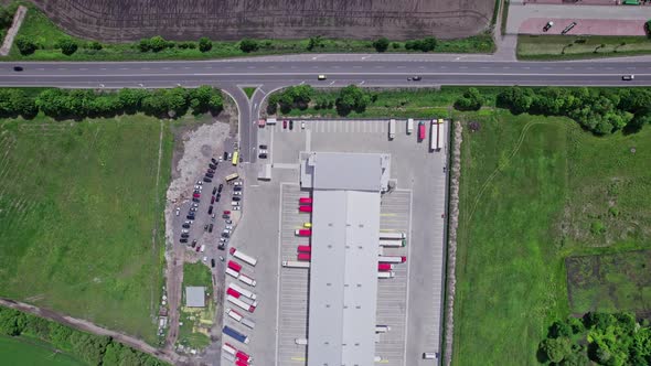 Aerial Top View of a of Semitrailer Truck Traveling Through the Parking