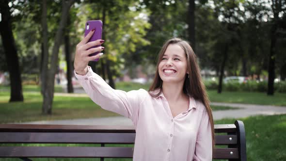 Woman taking selfie portrait, tourist girl making video call, chatting with friends.