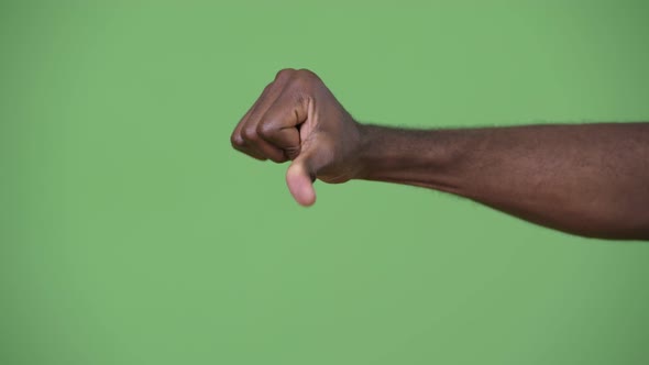 Hand of Young African Man Giving Thumbs Down