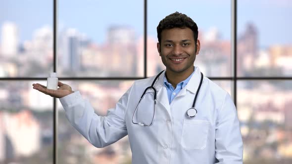 Smiling Male Doctor Presenting Pills in His Palm