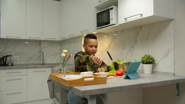 Adorable Boy Following Video for Making Breakfast to Mom at Home